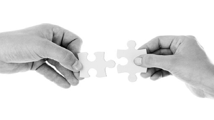 deux mains qui tiennent deux pièces de puzzle qui se complètent-société offshore-Buroservices