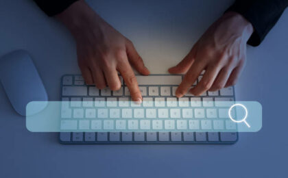 une barre de recherche avec une main tapant sur un clavier en fond - métiers du web - Buro Services